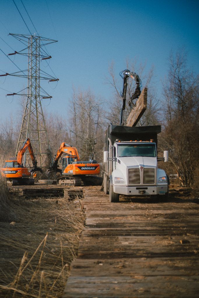Heavy equipment clearing a right-of-way access corridor